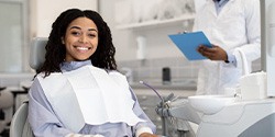 Woman smiling while sitting in treatment chair