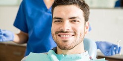 Man smiling after receiving dental implants in Edmond