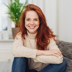 a woman smiling after getting her dental bridge