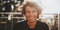 man smiling after receiving a dental bridge