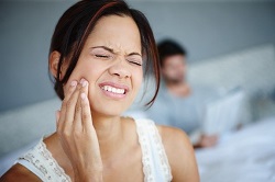woman experiencing dental pain before emergency dentistry