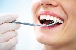 woman with bright healthy smile after same day dental crown restoration