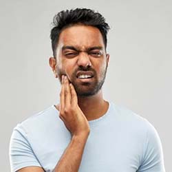 Man with toothache should visit his emergency dentist