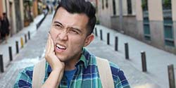 Man with toothache has questions for his emergency dentist