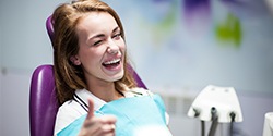 happy young woman in dentist chair after family dentistry