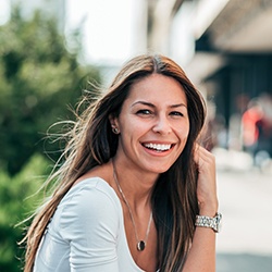 A portrait of a woman smiling outdoors