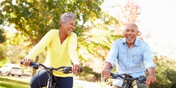 couple laughing on a bike ride together 
