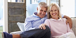 older couple smiling after dental implant tooth replacement