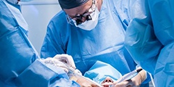 dentists performing dental implant surgery