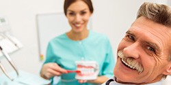 Smiling senior man in dental chair