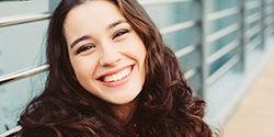Closeup of teen girl smiling outside