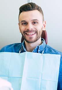 Man smiling while getting a dental checkup