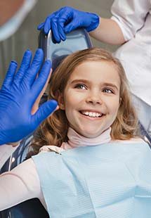 Child smiling and giving dentist a high five