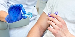 Dentist and patient inspect mouthguards