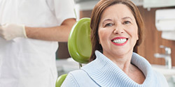 older woman smiling during dental checkup and teeth cleaning visit