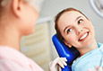 young woman smiling at dentist during preventive dentistry visit