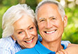 older couple smiling after restorative dentistry