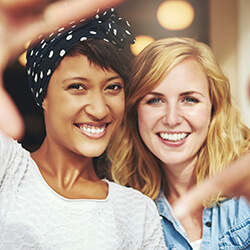 Two women sharing flawless smile after cosmetic dentistry