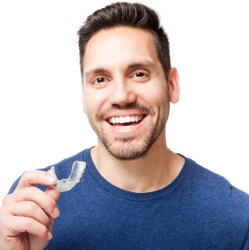 man holding invisalign tray