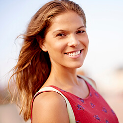 woman smiling outside after periodontal therapy