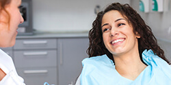 woman smiling bright at dentist