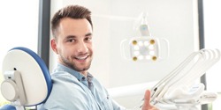 smiling man giving thumbs up before tooth extraction in Edmond