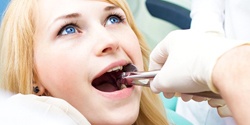 young woman getting a tooth extracted