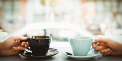 Two people drinking coffee which can stain teeth