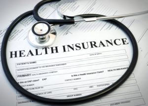 white insurance form with stethoscope 