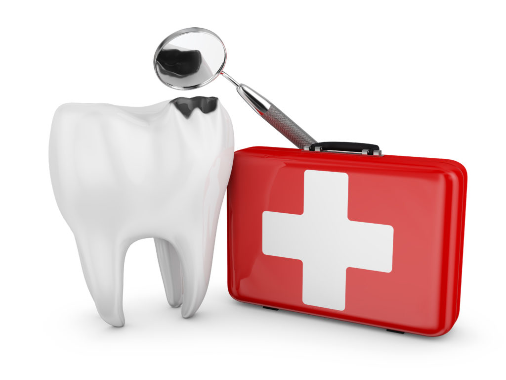 A tooth next to a first-aid kit 