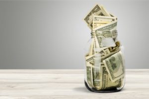 jar of money sitting on a counter