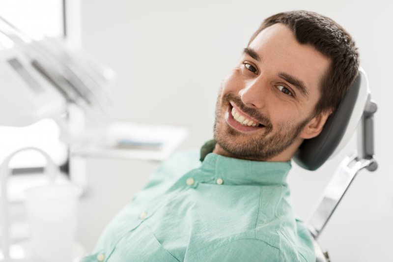 man sitting in dentist chair