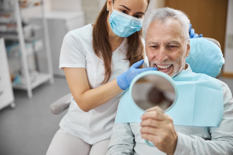 older man smiling with dental implants