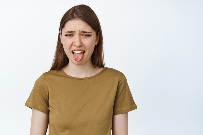 young woman with bitter taste in mouth