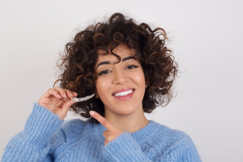 Patient holding Invisalign aligners