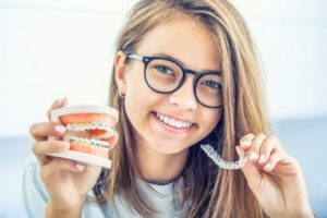 girl deciding between Invisalign and braces