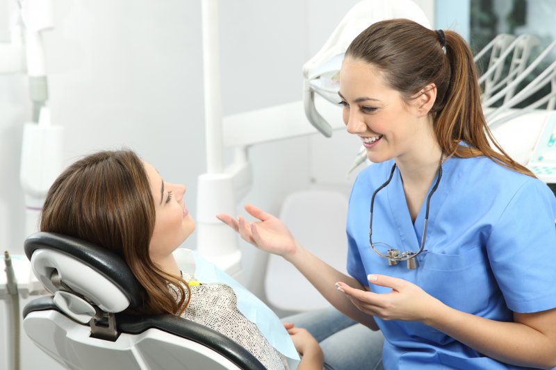 dentist speaking to patient about color-matching dental crowns
