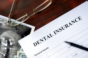 Dental insurance plan on table with glasses and X-rays